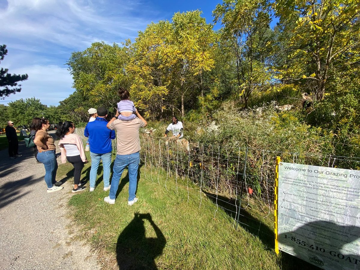 Children and adults view the live grazing demonstration.